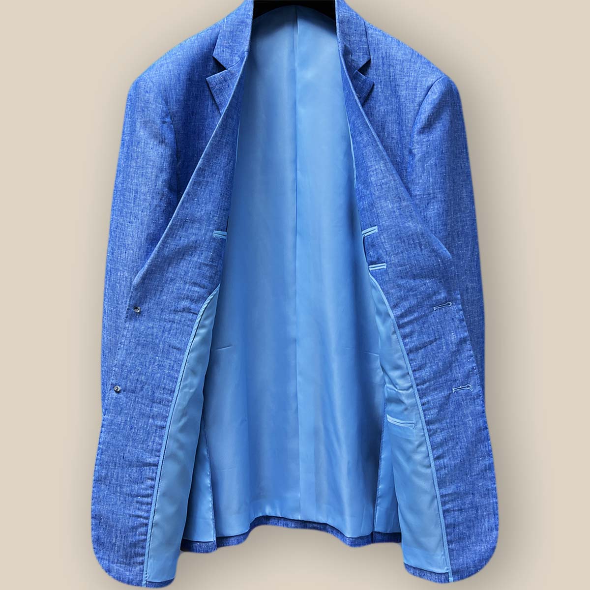 Full interior view of light blue solid Irish linen men's suit jacket, displaying sky blue bemberg silk lining