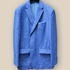 Close-up of light blue solid Irish linen men's suit jacket showing blue horn buttons and buttonholes