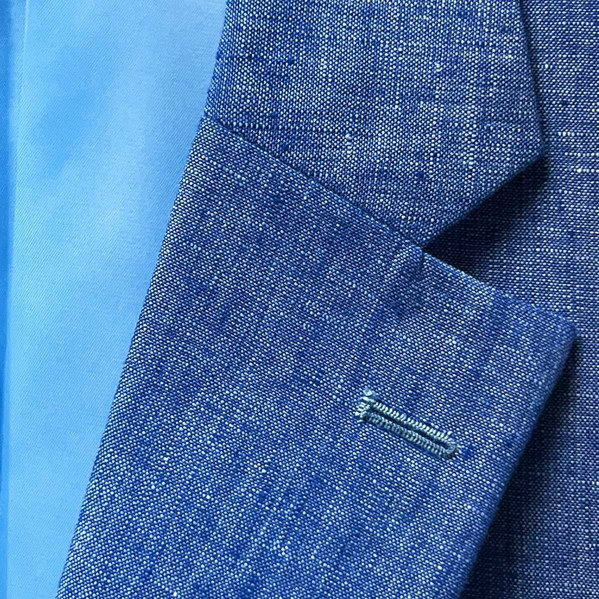 Detail shot of notch lapel on light blue solid Irish linen men's suit jacket