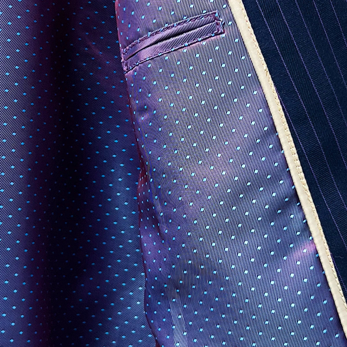 Inner lining ensuring comfort and a smooth fit in a navy suit with purple pinstripes.