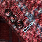 Close-up of working sleeve buttonholes with sky blue accent stitching