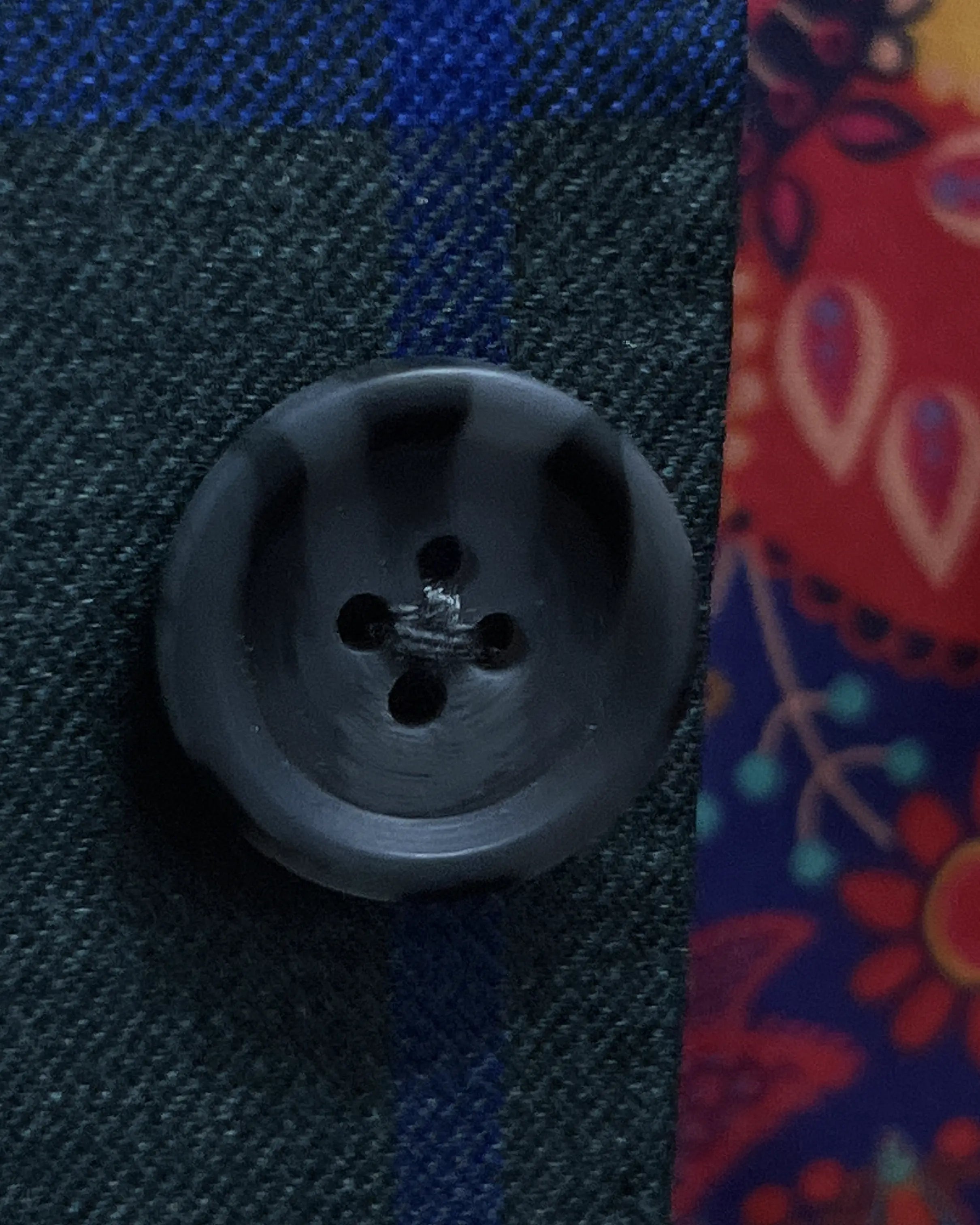 Button detail of Deep Teal Green Windowpane men's sport coat showing dark charcoal horn buttons
