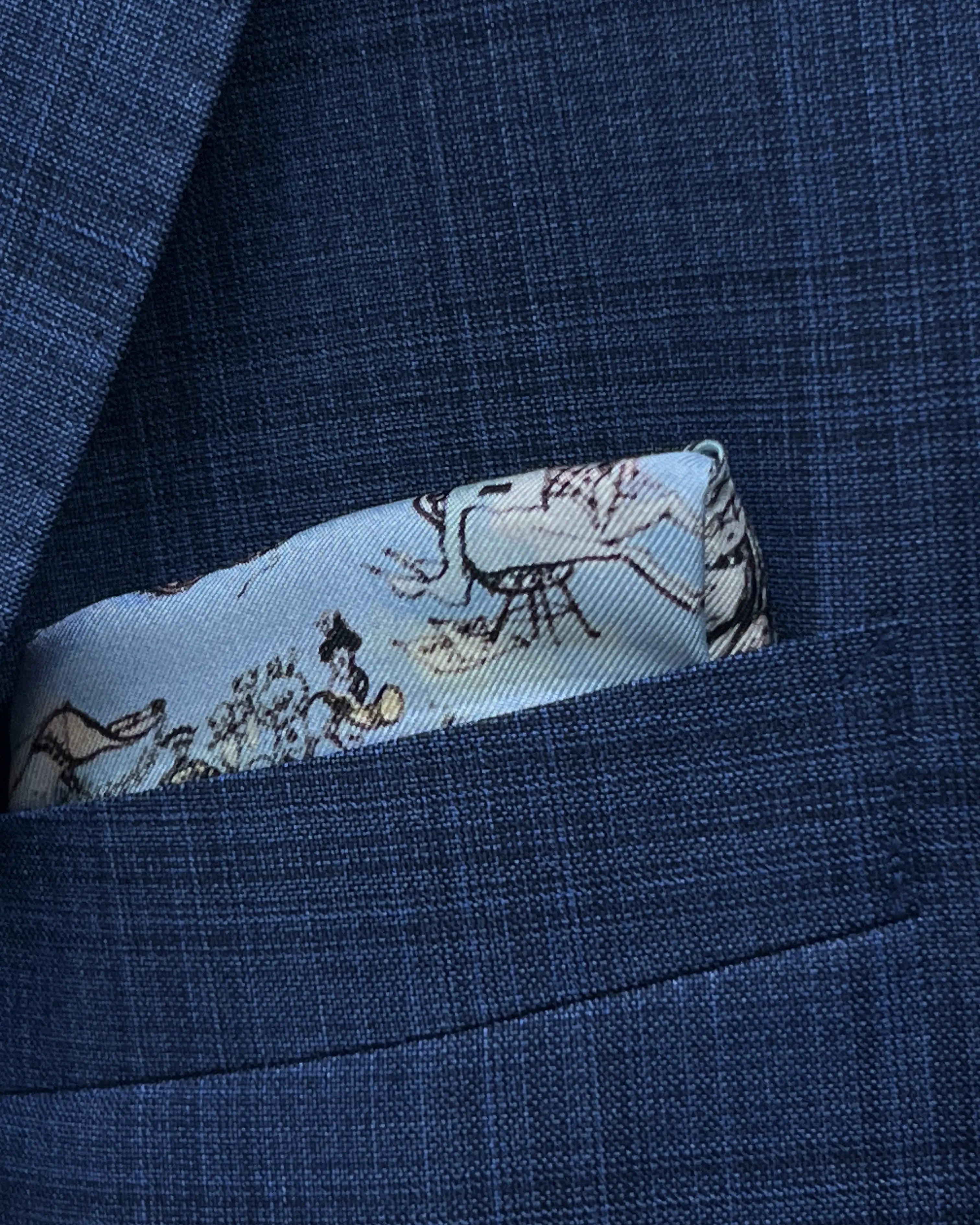Pocket square detail of blue windowpane check men's suit showing built in matching lining pocket square