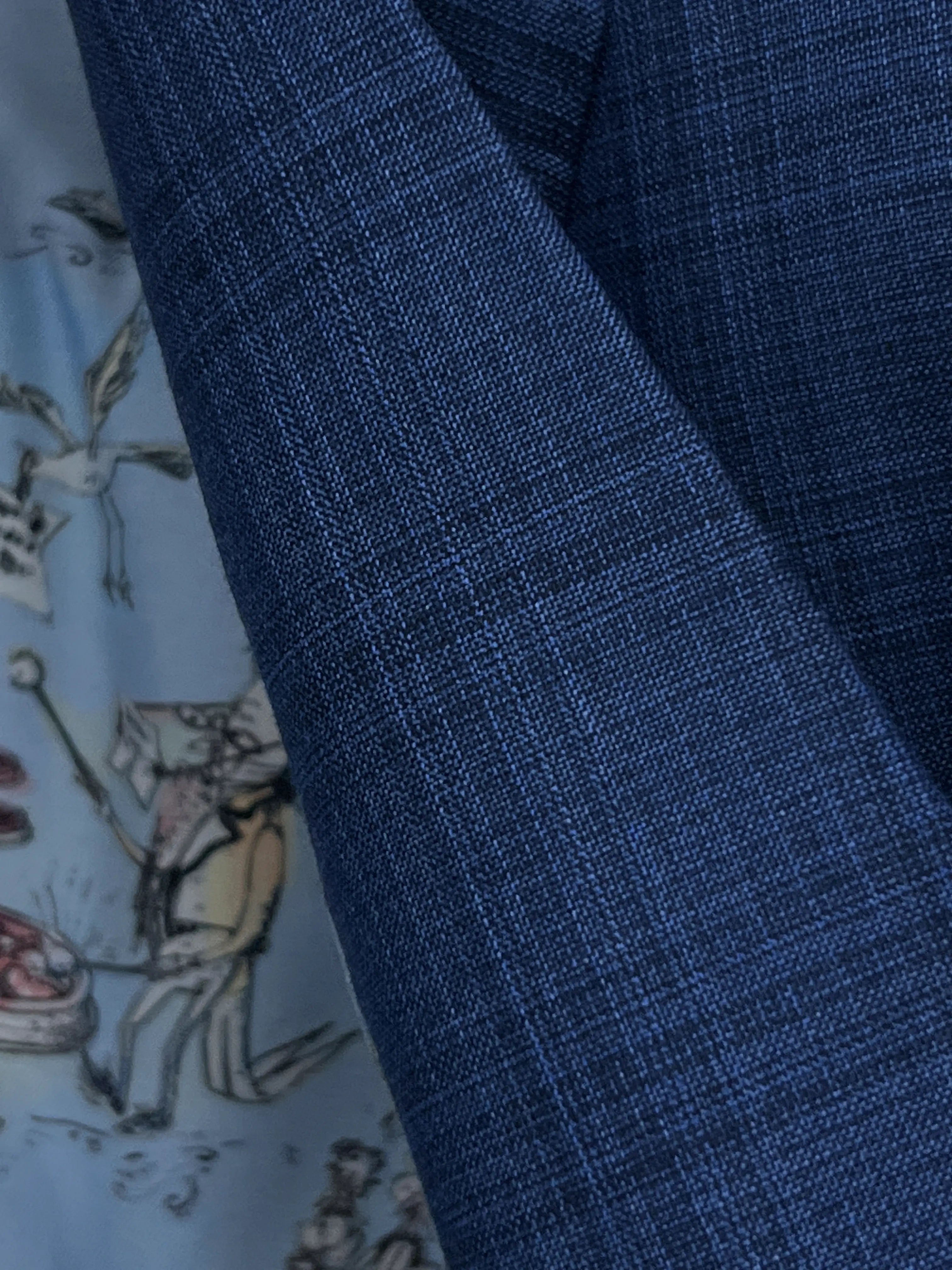 Fabric close up of blue windowpane check men's suit showing crisp worsted crosshatch texture