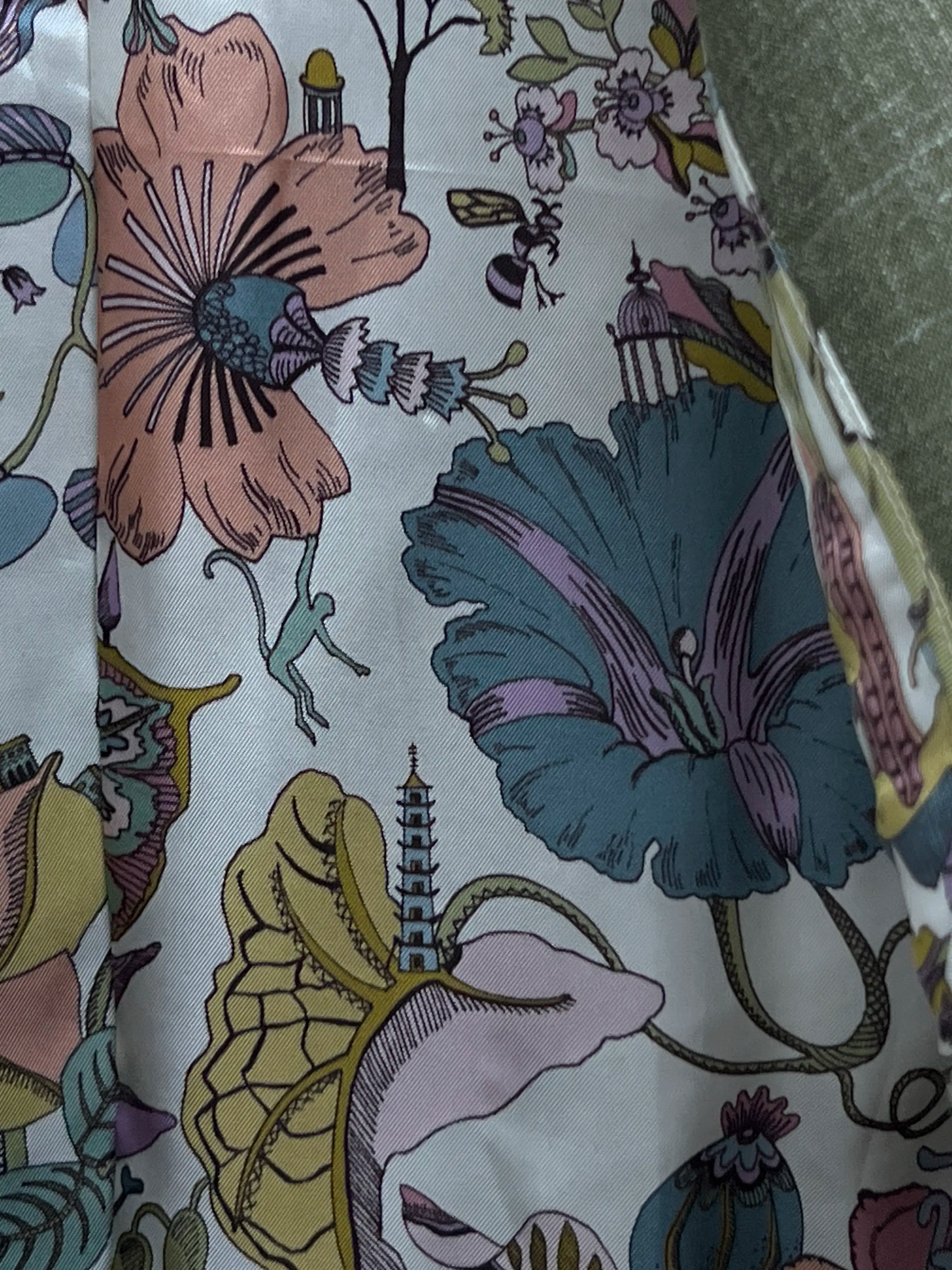 Interior lining of sage green plain men's suit showing botanical chinoiserie illustration print lining