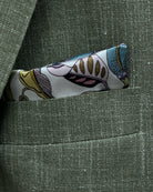 Breast pocket of sage green plain men's suit showing matching botanical print lining pocket square
