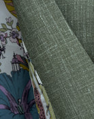 Close-up of Loro Piana fabric on sage green plain men's suit showing open weave slub texture