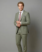 Mid-thigh editorial view of sage green plain men's suit showing lining glimpse and lapel detail