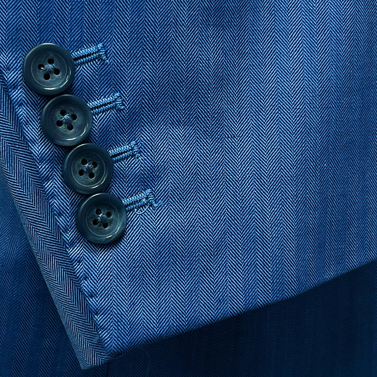 Blue herringbone suit designed for the discerning man, tailored to perfection near you.