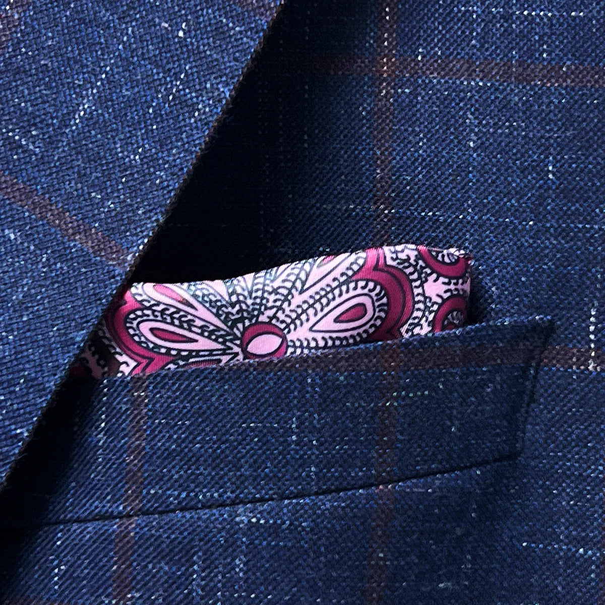 Navy windowpane sport coat chest pocket with coordinating pocket square placement showing styling possibilities and proportion