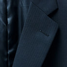 Classic notch lapel design on a sophisticated black herringbone suit.