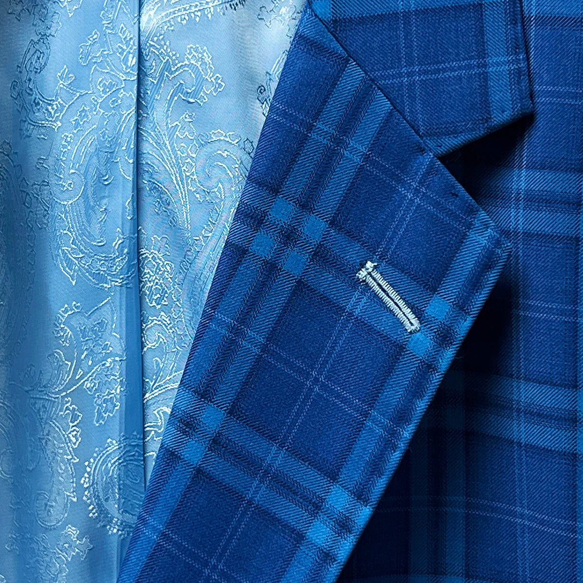 Lapel showcasing tailored precision on a colbalt blue checkered plaid men's sport coat.