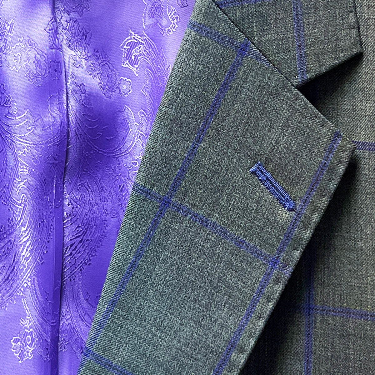 Notch lapel on a grey purple windowpane sportcoat.