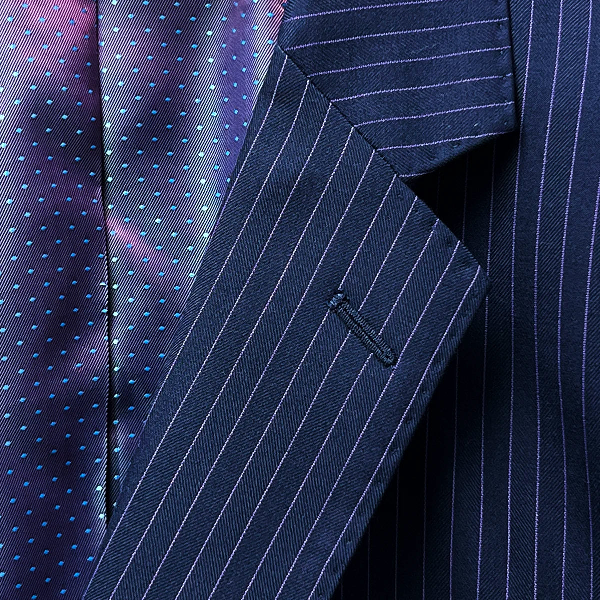 Notch lapel offering a classic style to a navy suit with purple pinstripes.