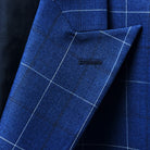 Peak lapel design on a navy blue windowpane suit