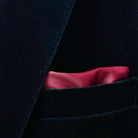Chic pocket square adding a touch of sophistication to a black velvet tuxedo suit dinner jacket.