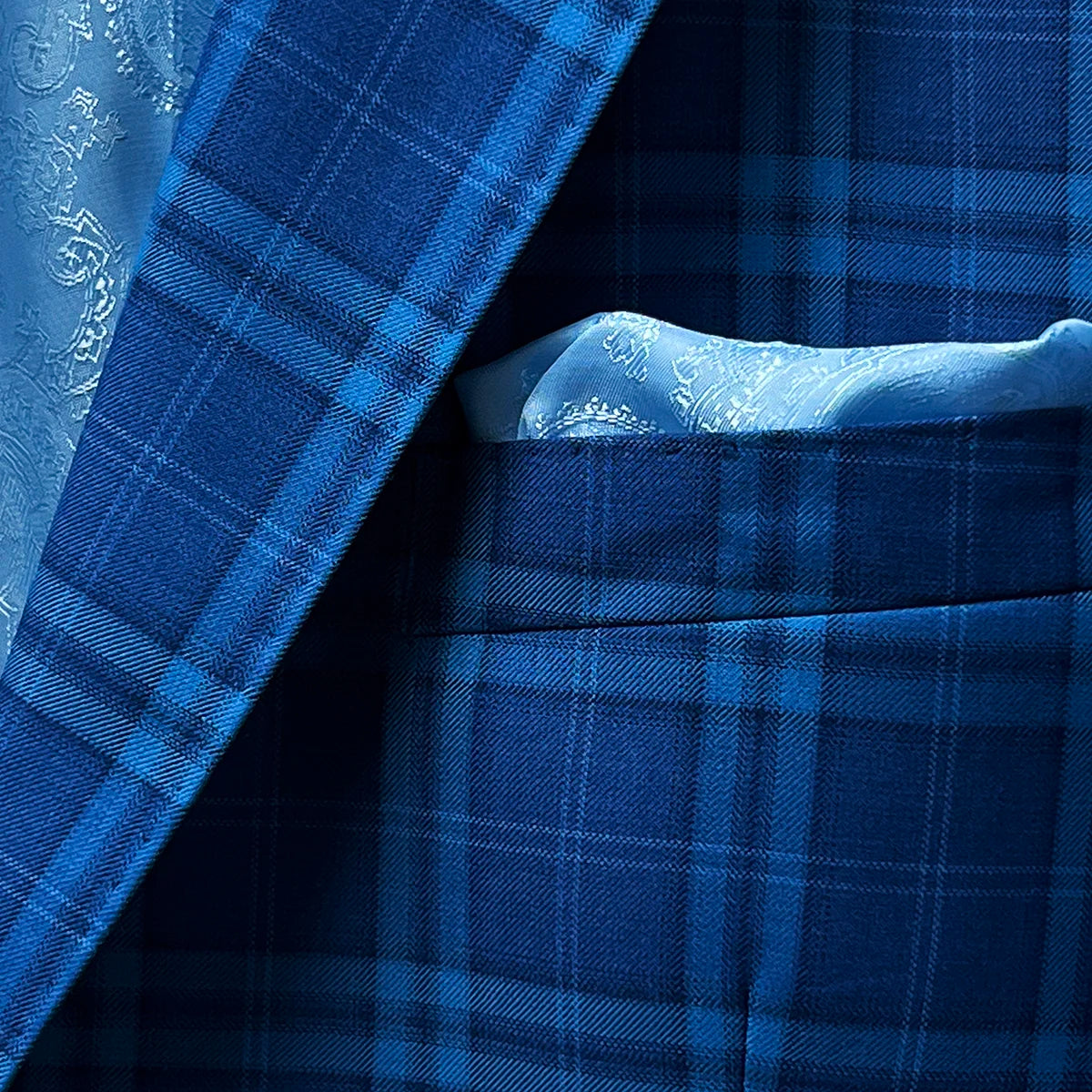 Pocket square adding a smart finish to a colbalt blue checkered plaid men's sport coat.