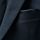 Pocket square accentuating the formal look of a dark gray sharkskin suit.
