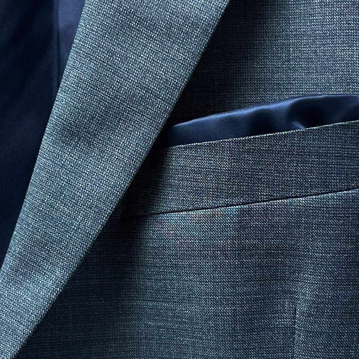 Coordinated pocket square enhancing the elegance of a dark grey nailhead suit.