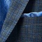 Pocket square accessory on a grey blue grid check flannel sportcoat.