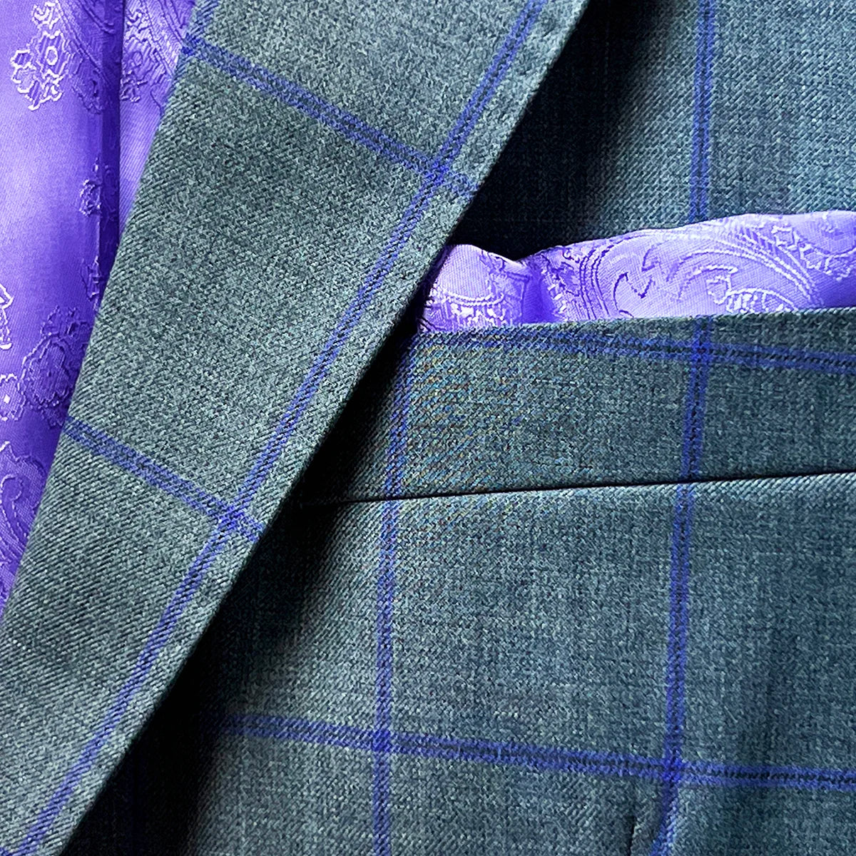 Pocket square in a grey purple windowpane sportcoat.