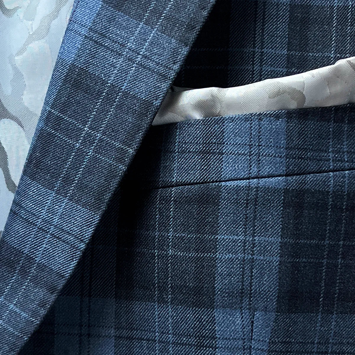 Pocket square on a Prussian Blue sportcoat with black grid checks.