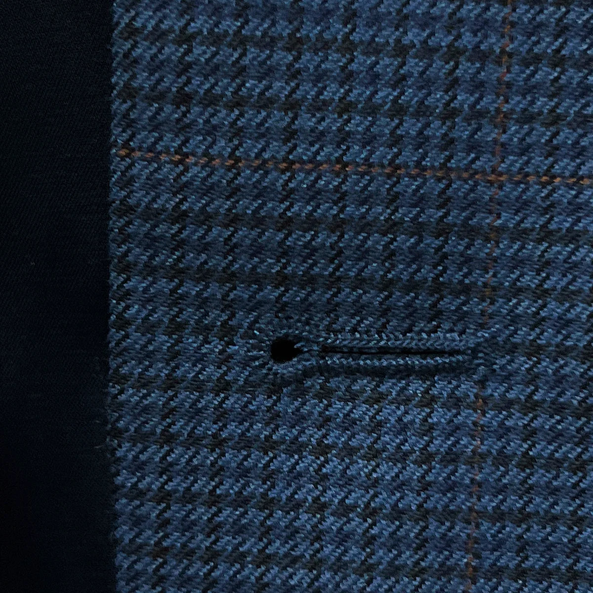 Detailed view of the buttonhole stitching on the prussian blue suit jacket, showcasing the quality and durability.