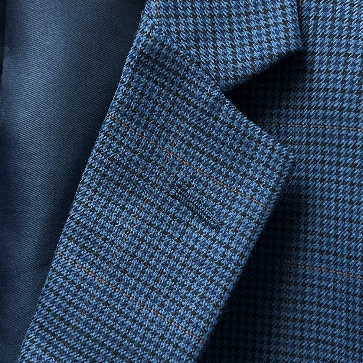 Detailed view of the notch lapel on the prussian blue suit jacket, featuring meticulous tailoring and a sharp finish.