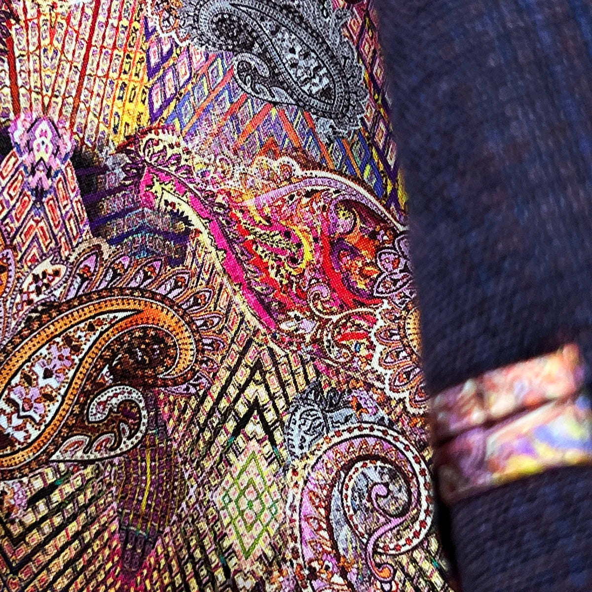 Detail of red-orange paisley lining flash when walking