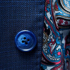 Close-up of the navy marble horn buttons on the royal blue suit jacket.