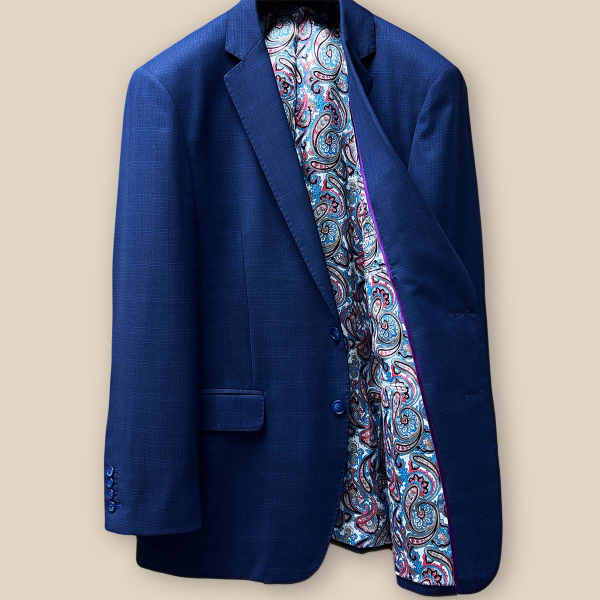 Inside left view of the royal blue suit jacket showcasing the multi-color fancy paisley print lining.
