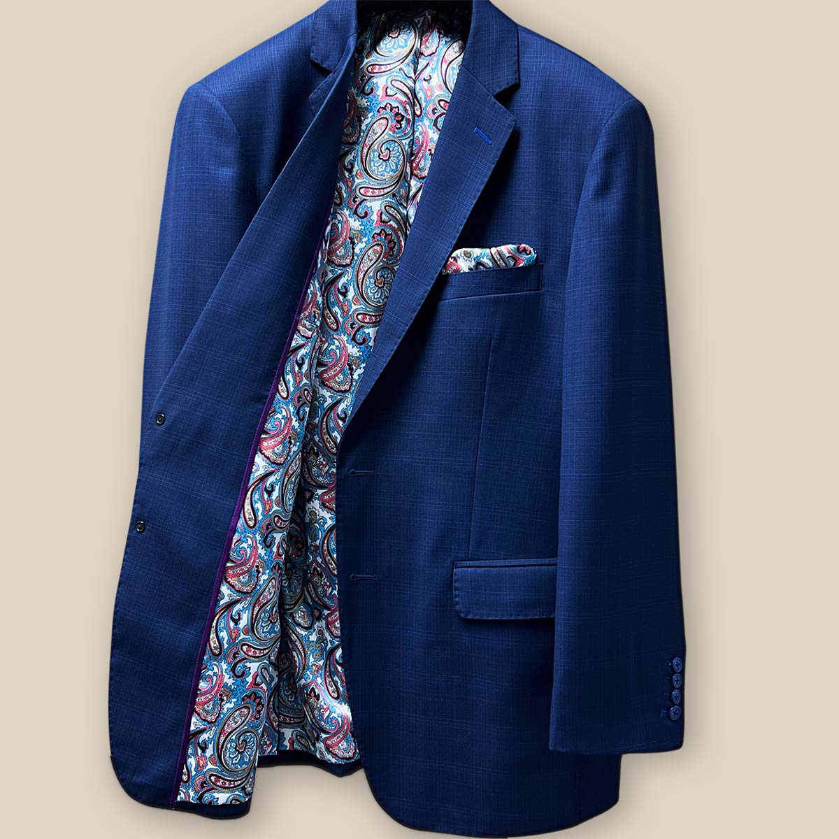 Inside right view of the royal blue suit jacket featuring additional pockets and the fancy paisley lining.