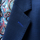 Detailed view of the notch lapel with pick stitching and royal blue contrast buttonhole.