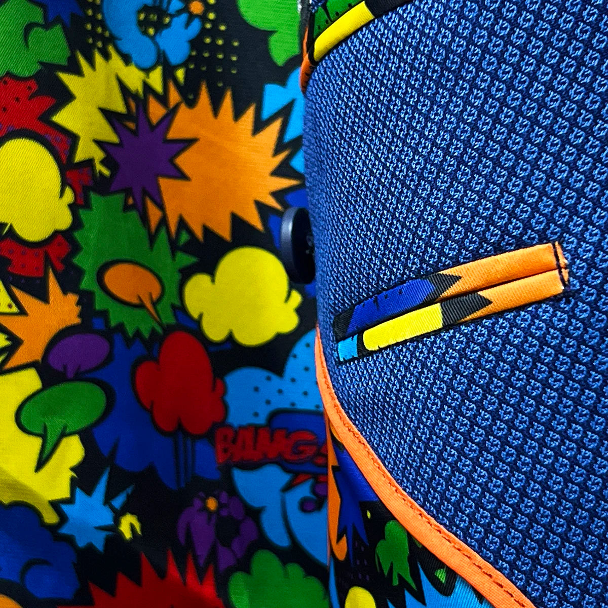 Inside view of the men's sapphire blue suit showing the colorful comics fancy lining with expressions like "wham!" and "pow!", bringing a playful element to the sophisticated attire.