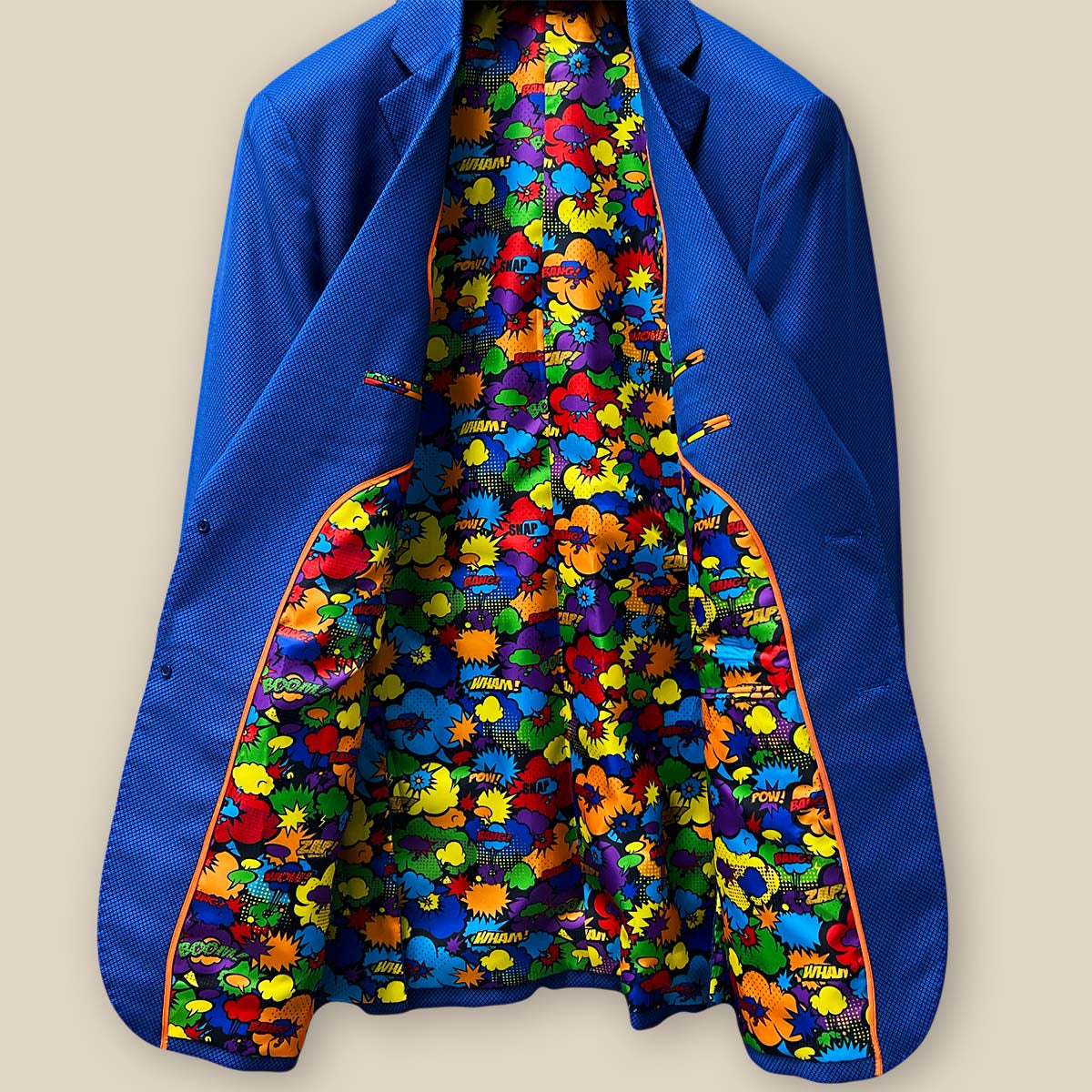 Overall inside view of the sapphire blue men's suit, displaying the comprehensive design and playful comic print lining.