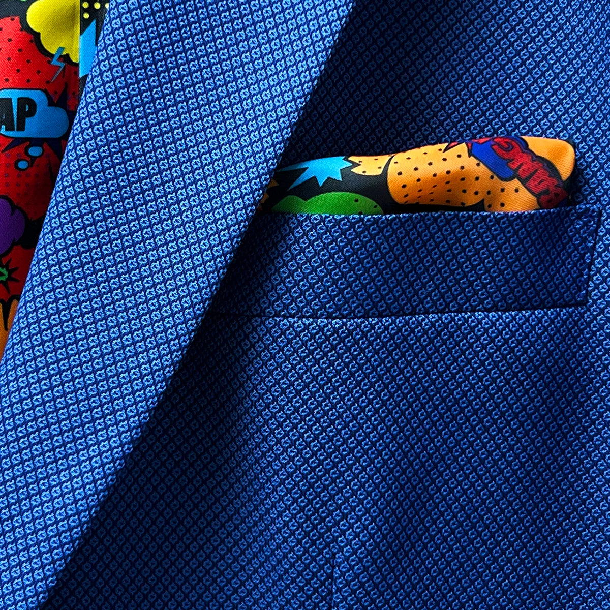 Suggestion of a stylish pocket square that complements the sapphire blue suit, ideal for adding a personal touch to the outfit.