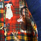 Colorful flash lining detail visible at jacket cuffs and vents in hunting lodge animal tartan print pattern