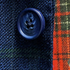 Close-up of navy marble horn buttons on deep blue navy emerald green overcheck suit jacket showing natural marble-like patterns