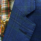 Classic notch lapel detail on deep blue navy emerald green overcheck suit jacket showing hand pick stitching and plaid pattern