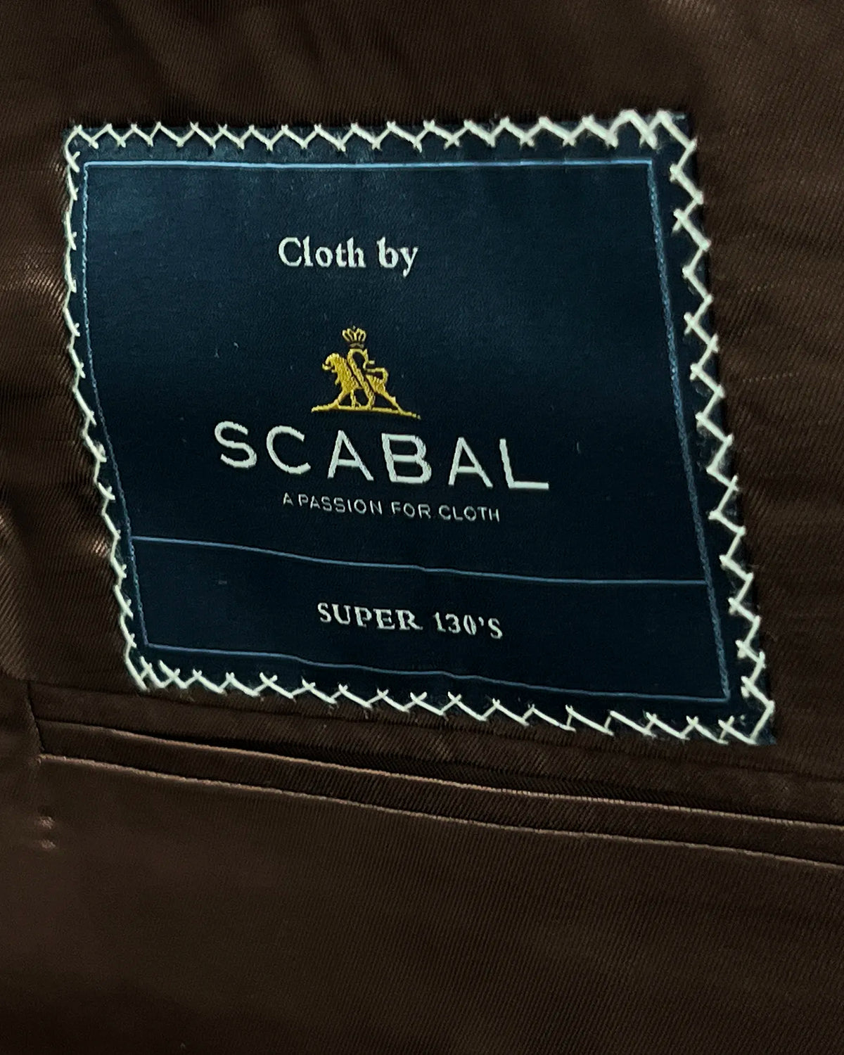 Mill label detail of light blue with tobacco brown glen check men's sport coat showing the Scabal label