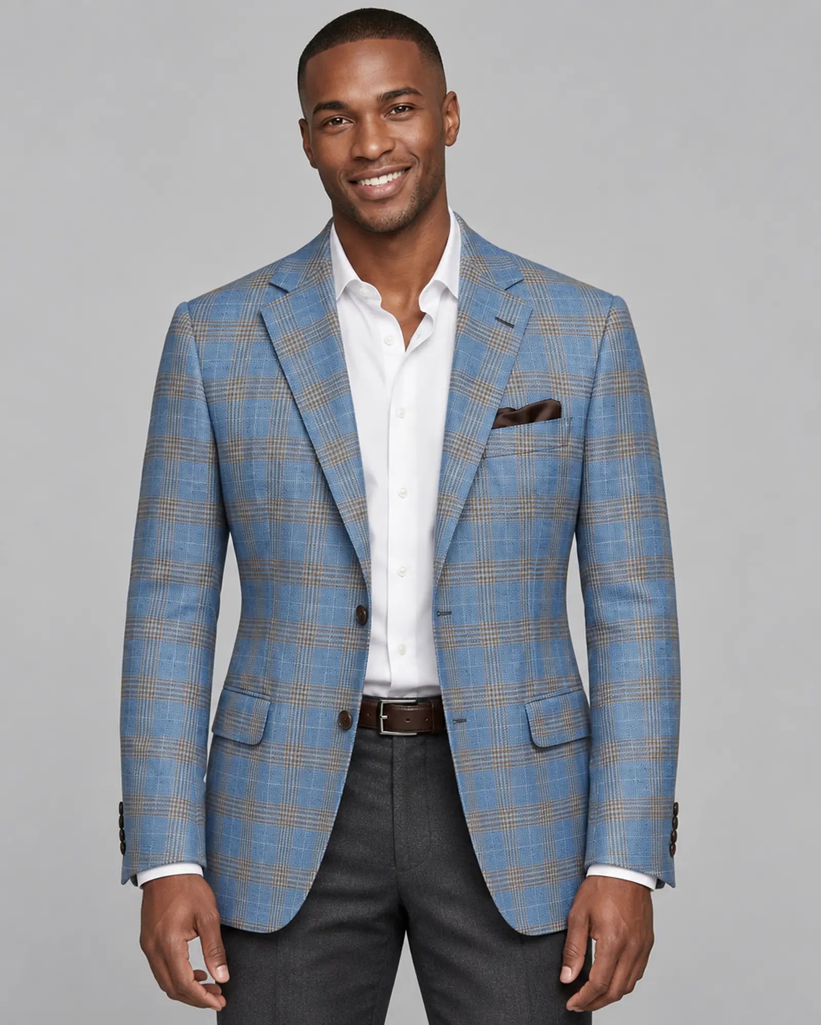Front model view of light blue with tobacco brown glen check men's sport coat showing the hero editorial look