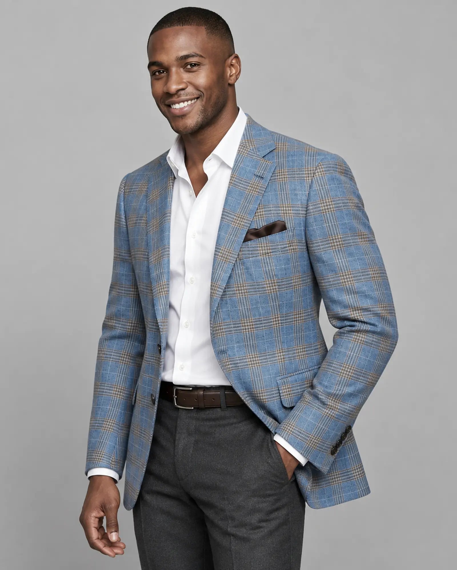 Side model view of light blue with tobacco brown glen check men's sport coat showing side stance and drape