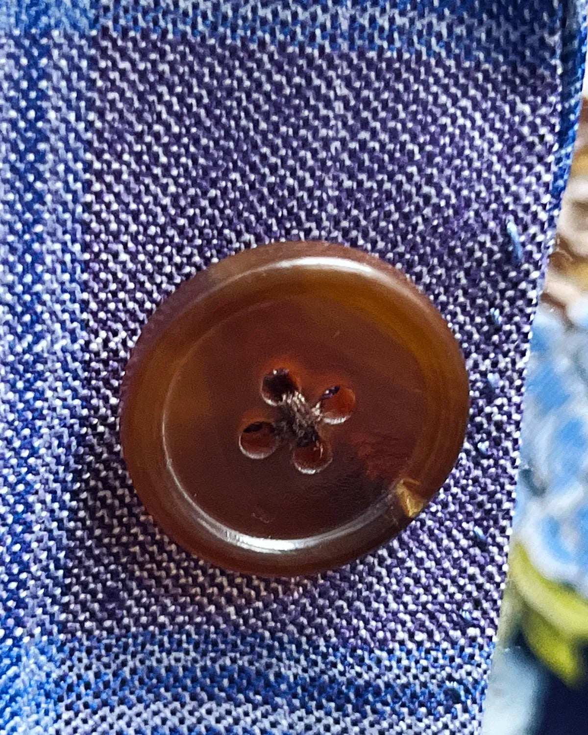 Button detail of lilac mauve with cornflower blue Glen plaid men's sport coat showing brown horn buttons