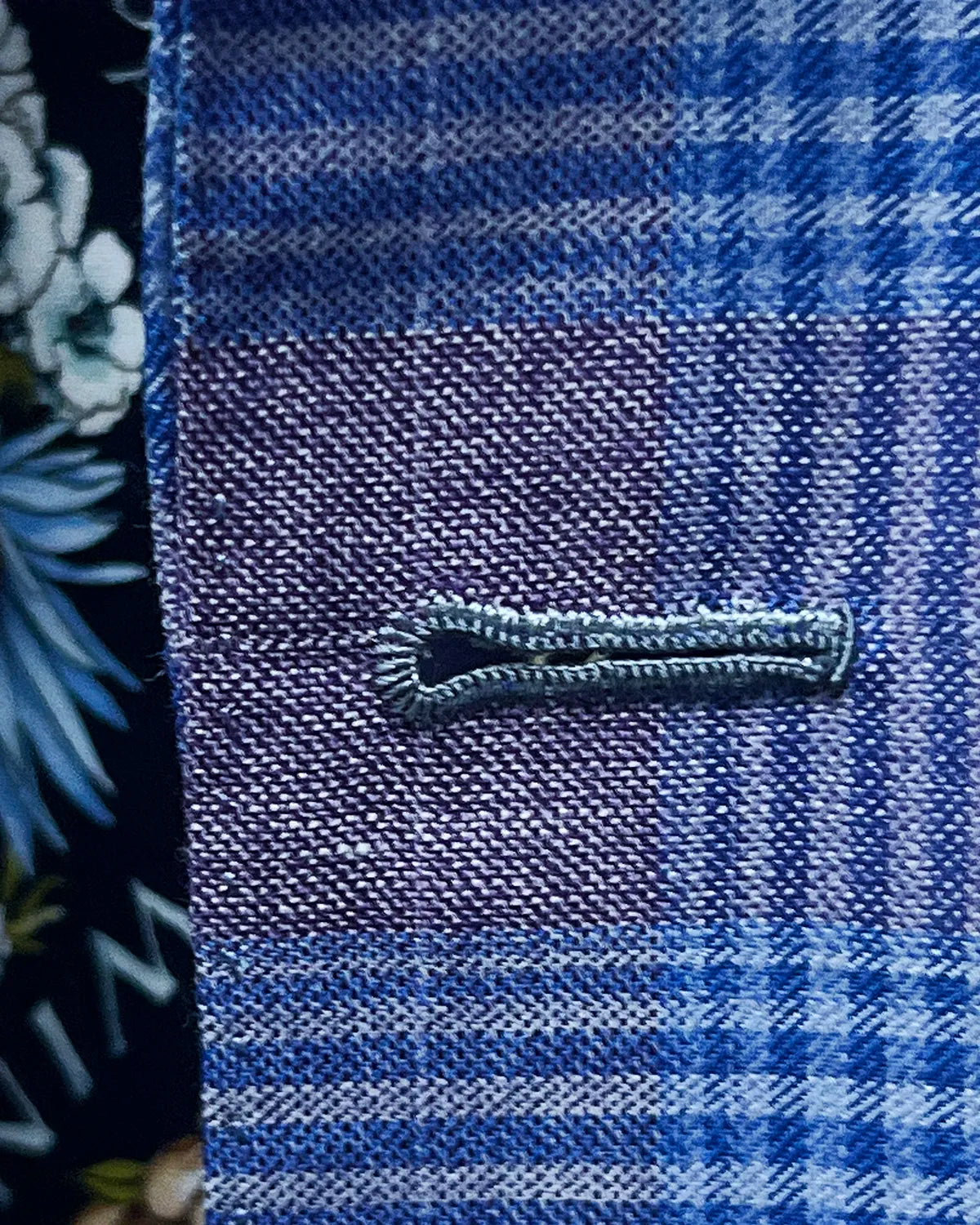 Front buttonhole detail of lilac mauve with cornflower blue Glen plaid men's sport coat showing the front buttonhole finish