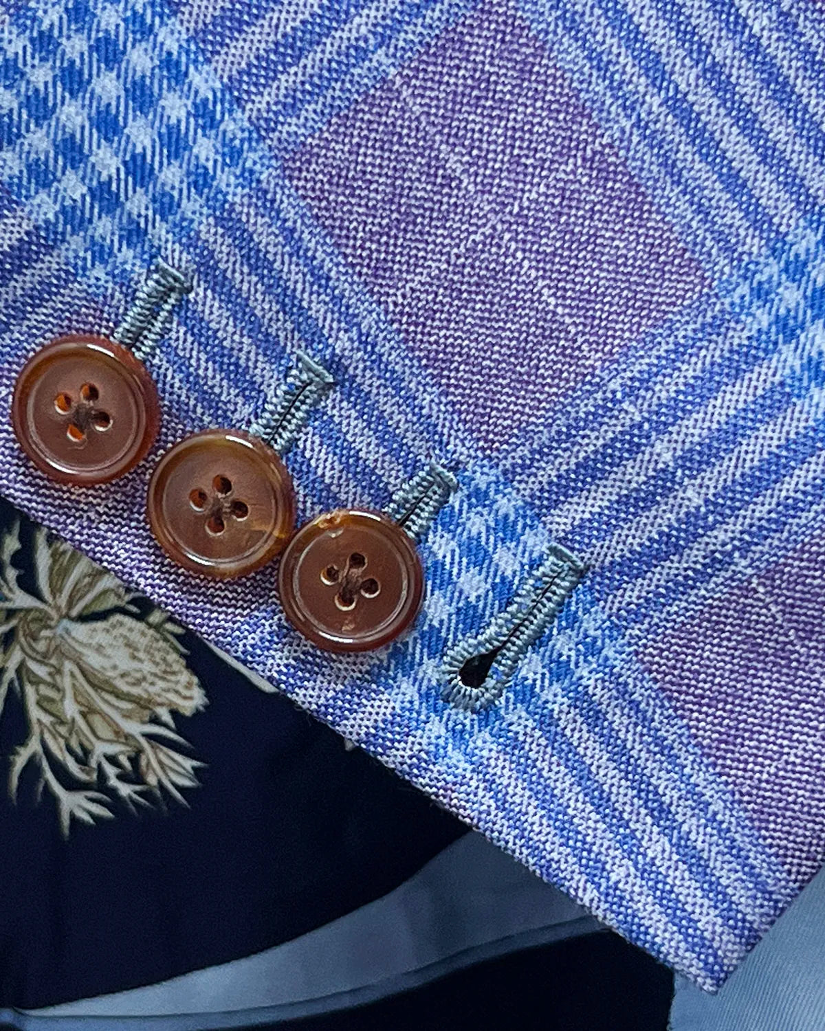 Sleeve cuff detail of lilac mauve with cornflower blue Glen plaid men's sport coat showing functional sleeve buttons
