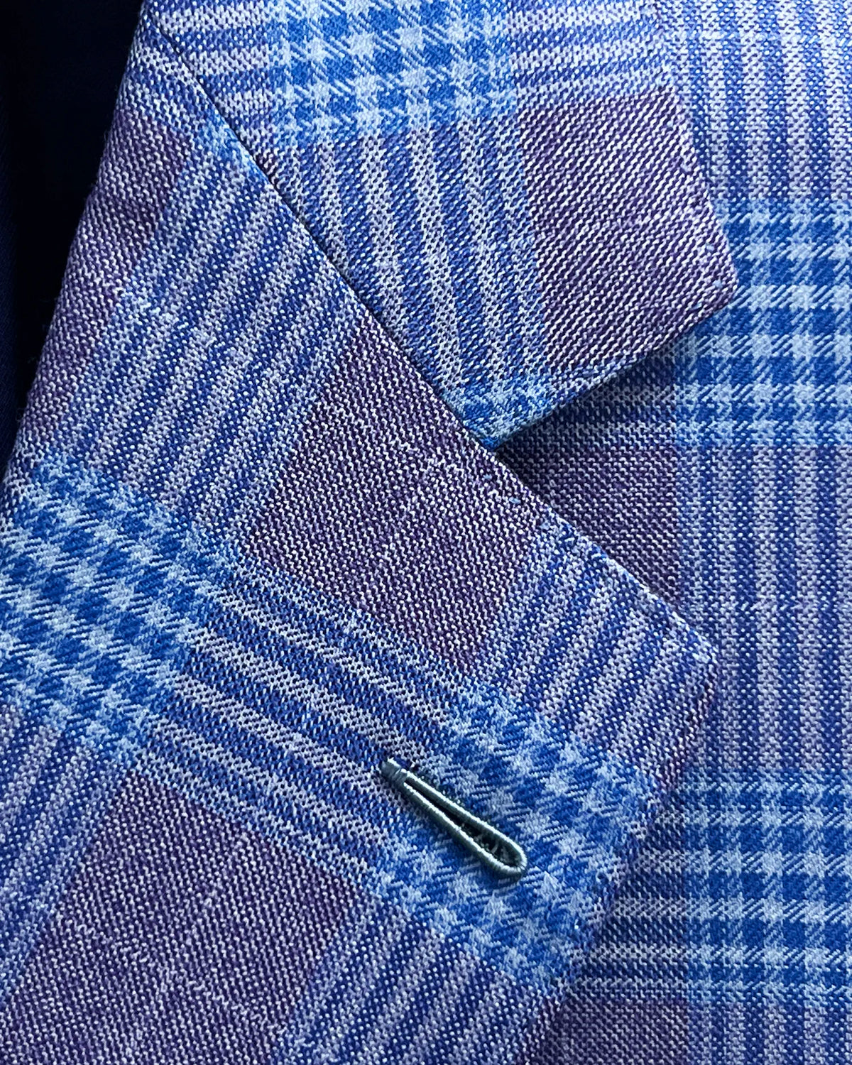 Lapel detail of lilac mauve with cornflower blue Glen plaid men's sport coat showing the Milanese lapel buttonhole