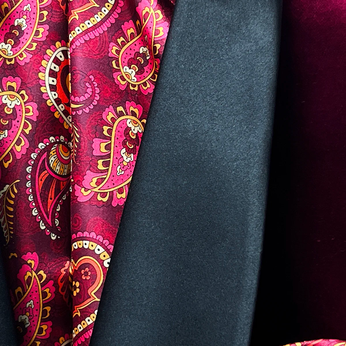 Shawl lapel on a rich burgundy velvet tuxedo jacket.