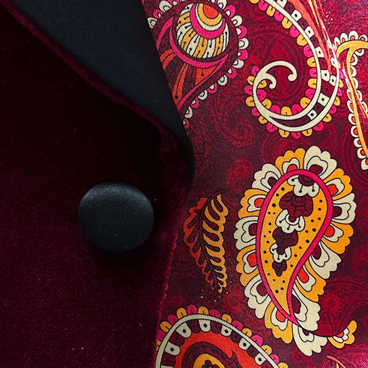 Elegant silk satin buttons on a burgundy velvet dinner jacket.