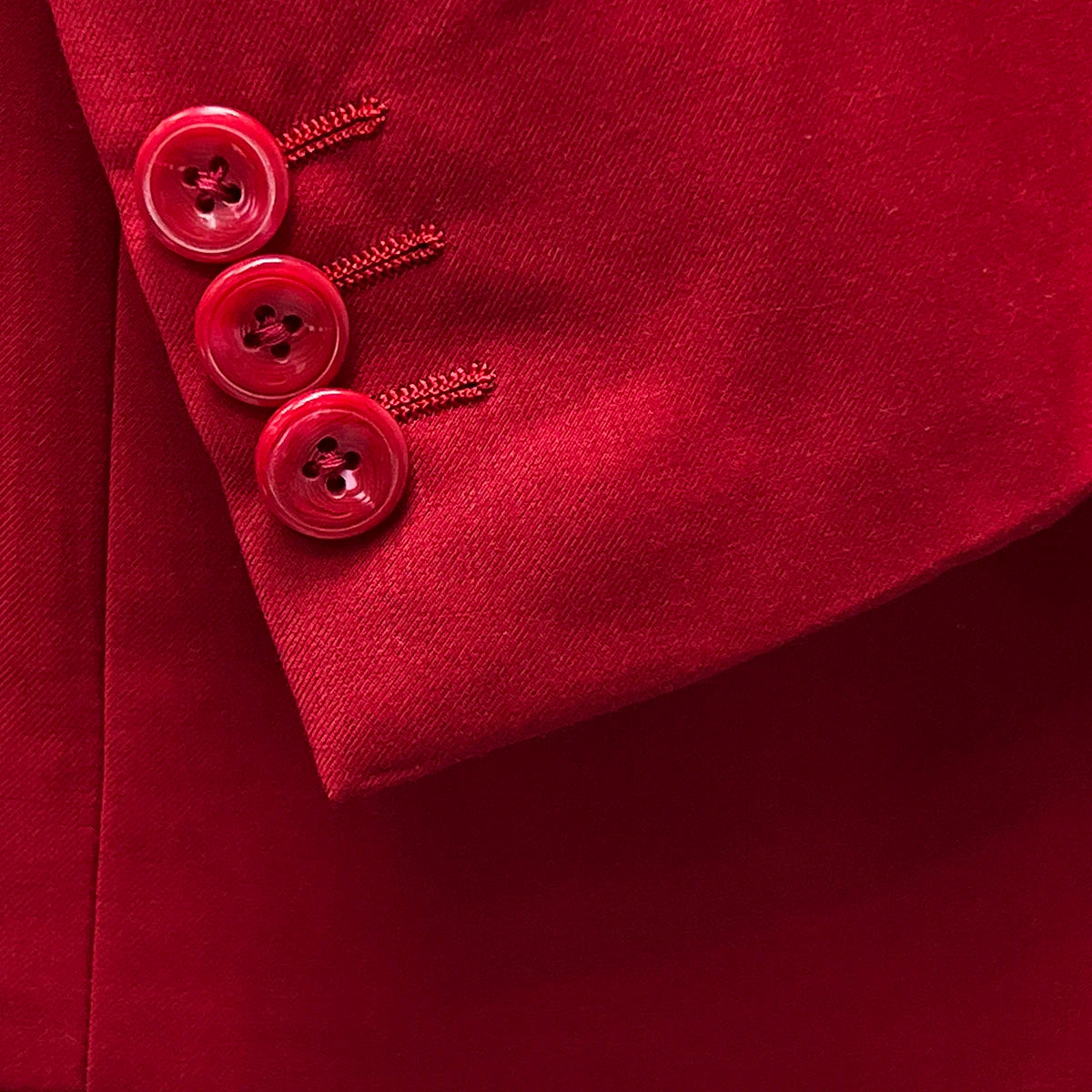 sleeve buttonholes allowing for precise sleeve length adjustment on a scarlet red, solid plain color suit.