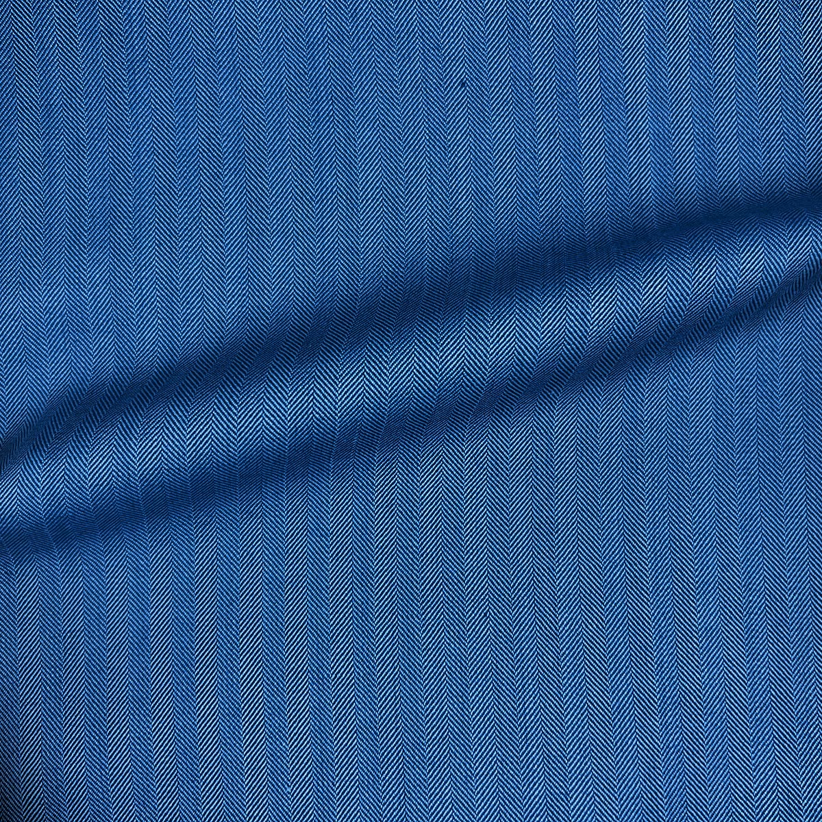 Get this blue herringbone men's suit, made from 100% Australian Merino wool, tailored near you.